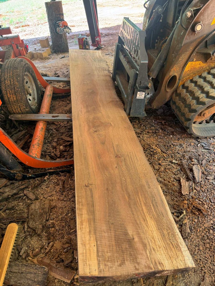 An open slab next to the skid steer, full length